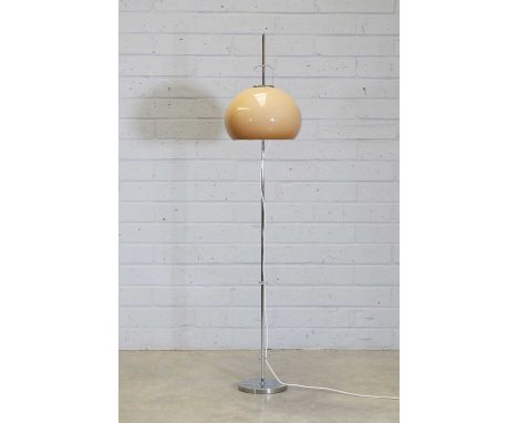 An Italian floor lamp, 1970s, designed Harvey Guzzini for Meblo, with a peach-coloured domed shade on an adjustable chrome co