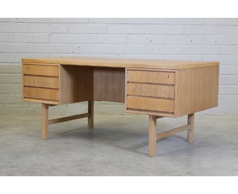 A Danish 'Model 76' oak desk, c.1965, designed by Gunni Omann for Omann Jun, the rectangular top raised on two banks of gradu