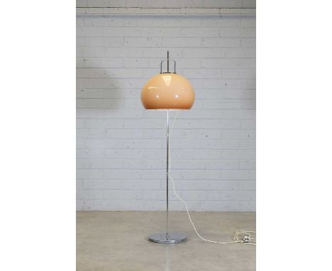 An Italian floor lamp,1970s, designed by Harvey Guzzini for Meblo, with a peach-coloured domed shade on an adjustable chrome 