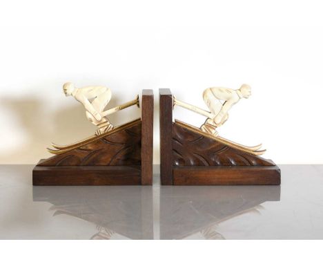 A pair of French Art Deco 'skier' bookends,  in the manner of Jamar, each with a carved fretwork phenolic skier, mounted on a
