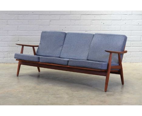 A Danish 'Model GE-270' teak sofa,designed in 1950 by Hans Wegner for Getama, with rounded paddle armrests, raised on turned 