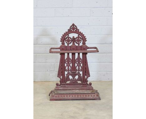 After a design by Dr Christopher Dresser,c.1875, a painted cast iron stick stand, the arched top over a pierced strapwork bac