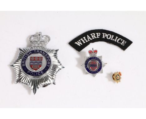 British Transport Police helmet plate, together with a cap badge and lapel badge to the same organisation, and a cloth Wharf 