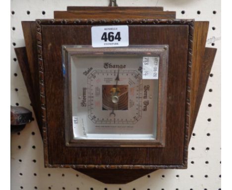 A mid 20th Century small oak cased wall barometer with visible aneroid works