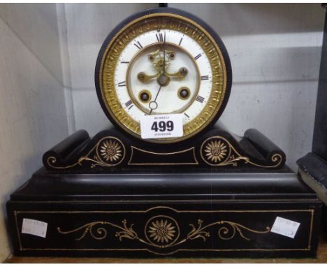 A late Victorian black slate cased drum and scroll mantel clock with Paris eight day bell striking movement and visible escap