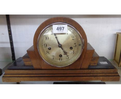 A 1930's walnut and part ebonised cased mantel clock with added platform escapement to German eight day gong striking movemen