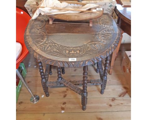 A 26" 1920's caved oak gateleg table, set on bobbin turned supports and decorative stretchers