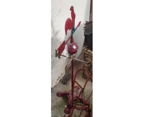 A vintage freestanding cast metal weather vane with cockerel finial - sold with a wrought iron saddle rack