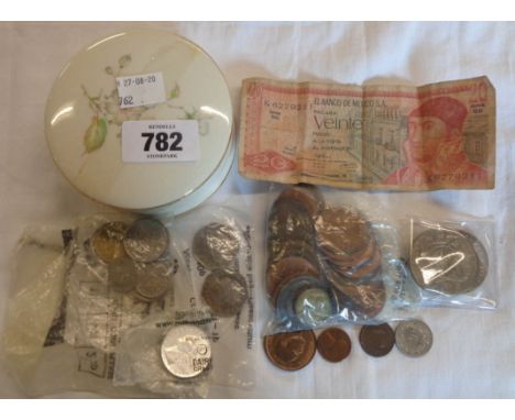 A ceramic pot containing assorted world coinage