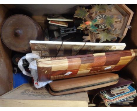 A box containing assorted collectable items including cuckoo clock, plated salad servers, cutlery, old roller skates, etc.