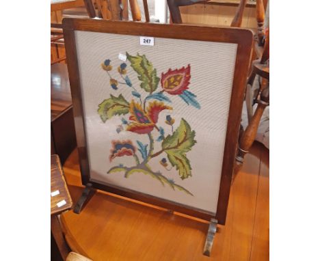 A stained oak framed fire screen with floral woolwork panel under glass - sold with a stained pine two tier jardiniere stand