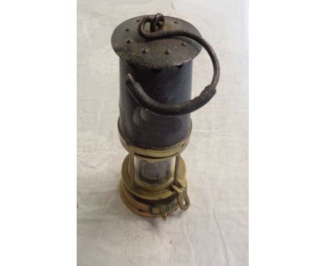An old brass and iron miner's lamp - converted to electric