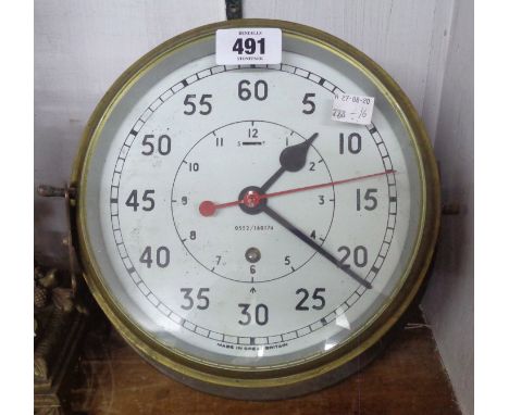 A 9" diameter brass cased bulkhead timepiece, the dial marked with broad arrow and 0552/160174 - mains spring for repair