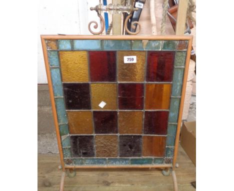 A late 19th Century tubular copper fire screen with stained glass panel - some damage to glass border