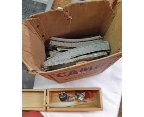 A box containing asorted vintage Tri-Ang railway track and a model aeorplane engine - for restoration