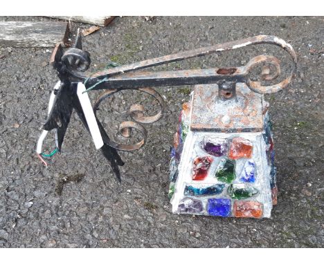 A vintage porch light on wrought metal bracket with inset coloured glass shard mosaic pattern shade