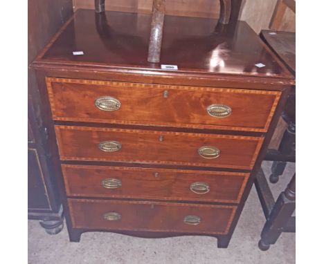 A 25" Edwardian mahogany and strung chest of four long drawers, set on bracket feet