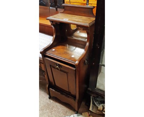 A late Victorian oak coal perdonium with mirror set shelf top and panelled fall-front - damage