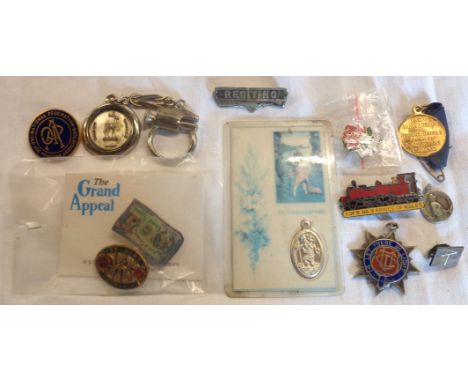 A small collection of badges including for Home and Country, Let there be Light and OAPA