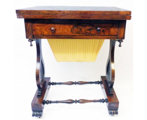 A 24" Victorian rosewood games/work table with chess board to fold-over top, paper lined frieze drawer and pleated upholstere