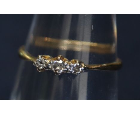 An 18ct gold diamond three stone ring. 1.1g approx.(B.P. 24% incl. VAT)