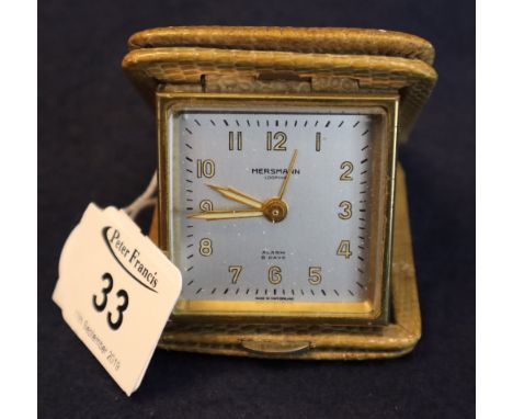 A Mersmann back winding travelling alarm clock in snakeskin case. (B.P. 24% incl. VAT)