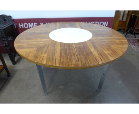 A Merrow Associates rosewood and chrome circular dining table, with white laminate lazy Susan to centre, model no. 342R, desi