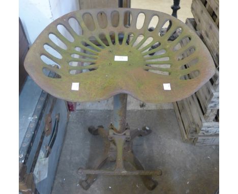 A cast iron tractor seat stool 