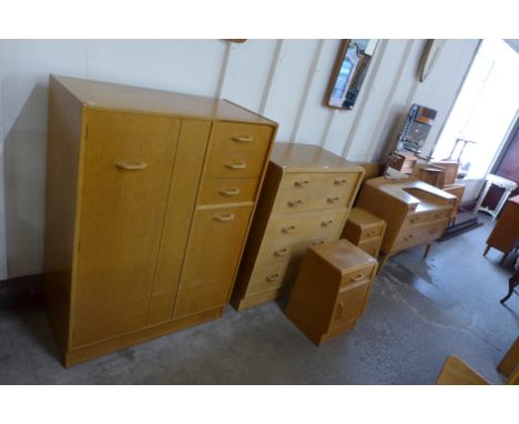 A G-Plan Brandon light oak bedroom suite, comprising; a chest of drawers, tallboy, dressing table, pair of bedside cabinets, 