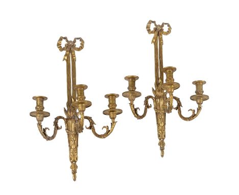 A set of four gilt metal three light wall appliques in Louis XVI style, 20th century, the dentil cast and beaded sconces on s