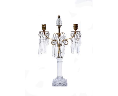 A Regency cut and moulded glass and gilt metal mounted twin light lustre candelabrum, elements circa 1820, with pinecone fini