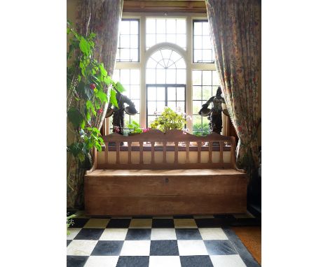 A North European pine box seat/hall bench, first half 19th century, with forward hinging seat and front, 102cm high, 184cm wi