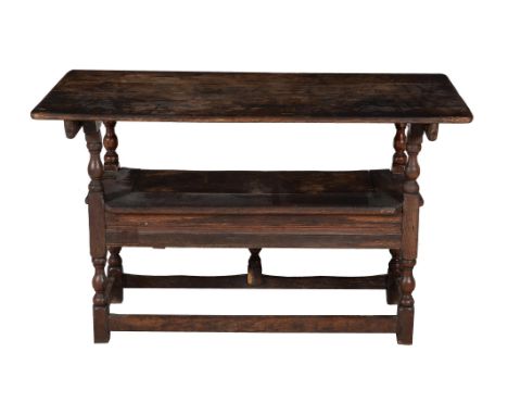 An oak Monk's bench or hutch table, late 17th century and later, as a table 77cm high, 122cm wide, 62cm deep 
