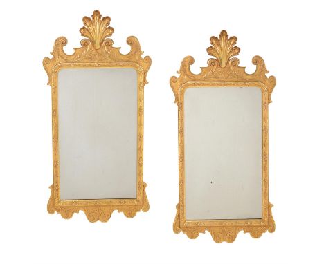 A pair of giltwood wall mirrors in mid 18th century style, late 20th century, each with fanned feather surmount, 105cm high, 