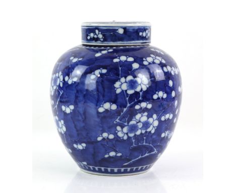 A blue and white oviform prunus jar and cover; the base with Kangxi four-character mark but not of the period, 24.5 cm high, 
