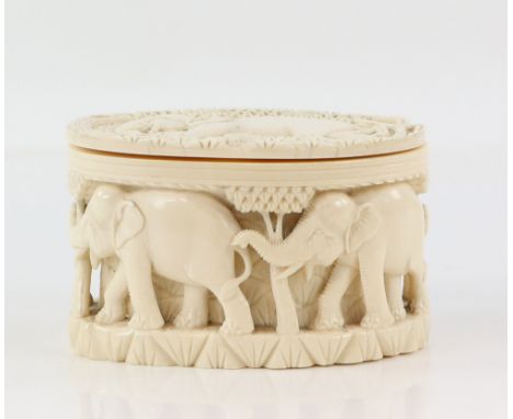 Early 20th century Indian carved ivory jar and cover decorated with elephants, 8.5cm high,PLEASE NOTE: THIS ITEM CONTAINS OR 