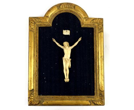 French 19th century, possibly Dieppe School, carved ivory 'Corpus Christi' with plaque 'INRI', figure 18cm high, frame 41cm x