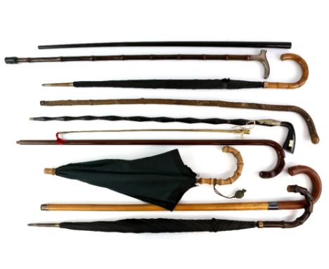 A collection of 21 vintage walking sticks , canes and umbrellas including cane with silver pommel, umbrella with embossed whi