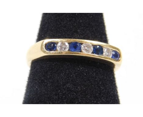 An 18ct gold half hoop eternity ring, set with sapphire and diamonds in tension setting, ring size N, 3.9g all in. 