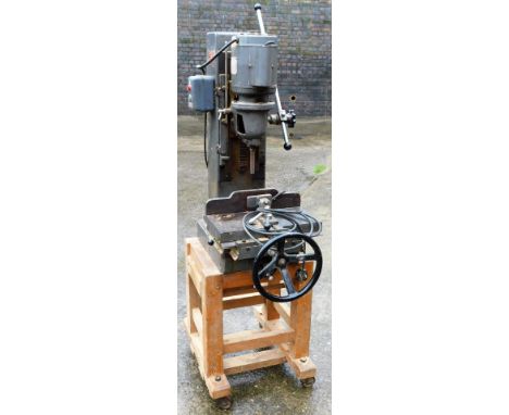 A Multico A1 industrial chisel mortiser, fitted with a Hoover AC motor, the front wheel on an associated pine stand, 150cm H 