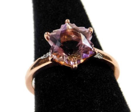 A 9ct rose gold modern dress ring, of star design, set with six pointed central stone in claw setting, the shoulders set with