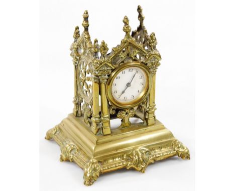 An early 20thC brass travel clock with watch centre, in elaborate case, on shaped feet, with 5cm Dia. Arabic dial and hand wi
