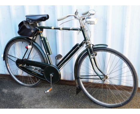 A vintage gentleman's Raleigh bike, in green with chrome trim, leather saddle, front and back dynamos and bell, 106cm high, t