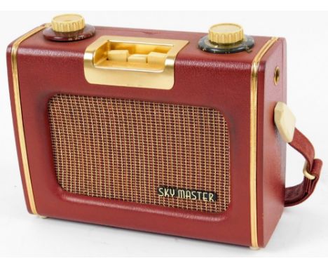 A vintage Sky Master radio, in pressed leather case with gilt coloured highlights, with Ever Ready label and fitted interior,