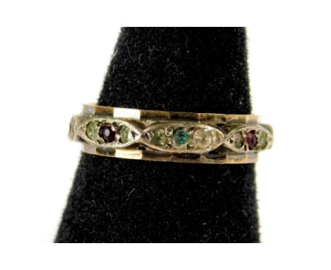 A dress ring, with red and white paste stones, on raised design, yellow metal, marked 9ct &amp; sil, 2.5g all in.