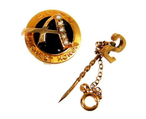Two pins, comprising a 9ct gold small pin, bearing the number 2 with safety chain, 2cm high, 0.7g, and an Avon Highest Honour