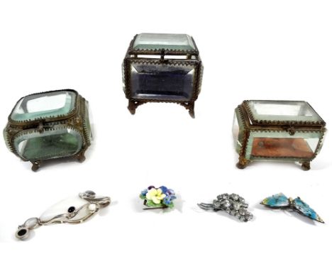 Three early 20thC glazed jewellery caskets, with five sided glass panelling and velvet lined interior, on shaped metal feet, 