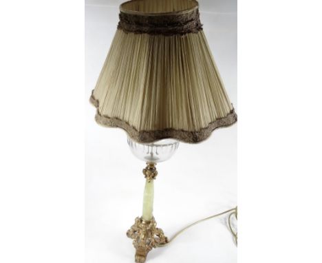 A 20thC oil lamp, converted to a table lamp, with clear glass reservoir, on onyx stem with pierced classical gilt metal base 