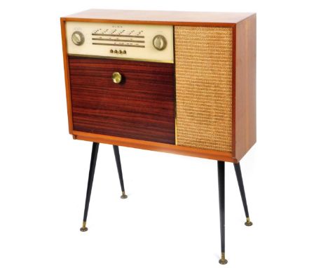 A Vintage Alba radiogram, with speaker front and articulated drawer, on turned ebonised legs terminating in metal disc feet, 