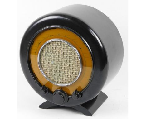 A vintage Bakelite Ekco circular radio, type A22, with 40/80 cycles, with tuning knops and a material grill front speaker, 45